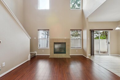 Unfurnished living room featuring a towering ceil