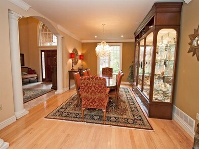 FORMAL DINING ROOM WITH HARDWOOD AND CROWN MOLDING