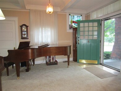 The spacious Entry and Living Rooms have beamed ce