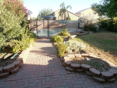 Brick walkway to gated pool