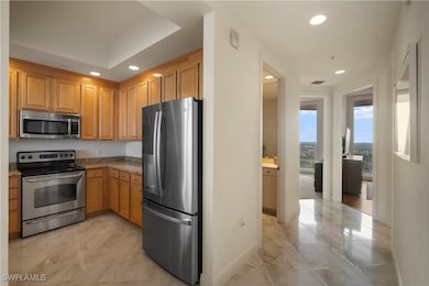 Kitchen with stone counters and stainless steel ap