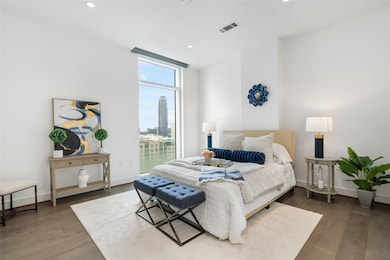 The primary suite boasts high ceilings, neutral pa