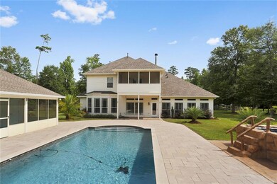 Attractive rear view of home with guest cottage on
