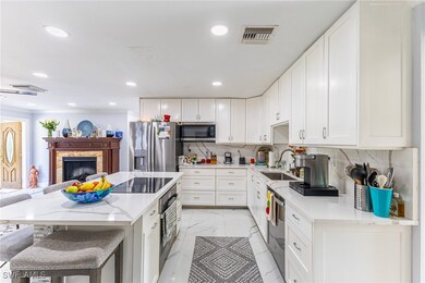 Kitchen with tasteful backsplash, visible vents, m