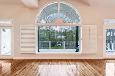 Den window with two sets of french doors accessing