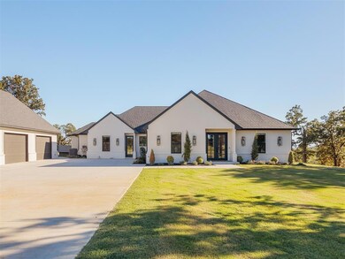 View of front of home with french doors, a garage,