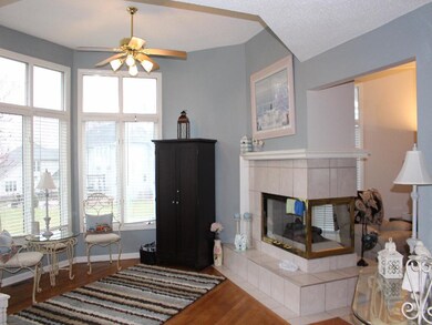 Hearth room, with wood flooring. Ceiling fan.