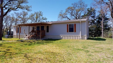 View of front of house with a front yard and metal