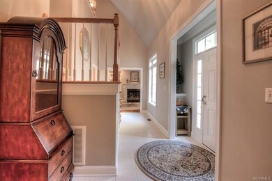Vaulted foyer with custom nooks on either side of the door.