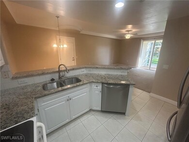 Kitchen with stainless steel dishwasher, a ceiling