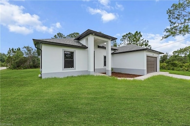 View of front facade with stucco siding, an attached garage, a front lawn, and a shingled roof