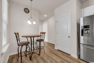 Dining space with light wood-type flooring