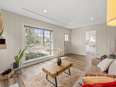 Huge picture window perfectly frames a blooming plumeria tree.