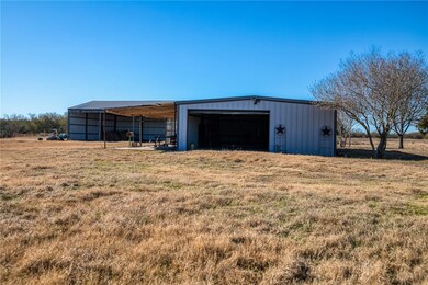 View of outdoor structure featuring a yard