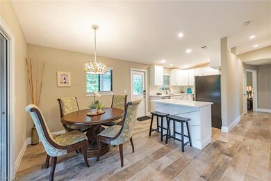 Dining space featuring sink, a chandelier, and lig