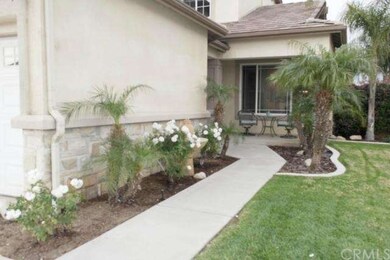 Beautifully landscaped front yard leads to front p
