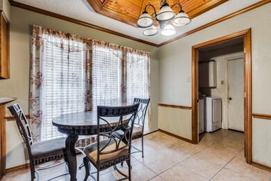 Tiled dining space with ornamental molding, wood c