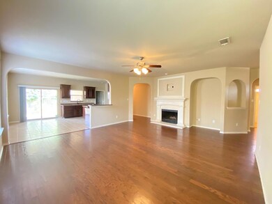 Unfurnished living room featuring ceiling fan and light tile floors