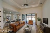 Living room featuring a raised ceiling, hardwood /