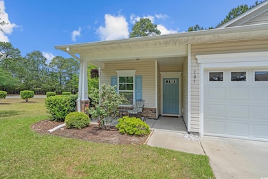 View of exterior entry with a lawn, brick siding, 