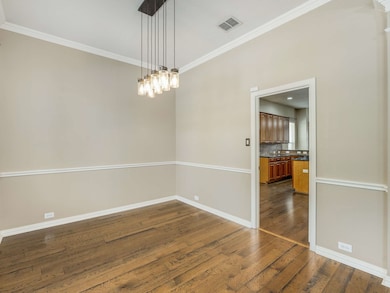 Empty room featuring crown molding and dark wood finished floors