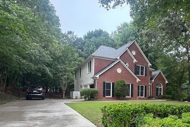 View of front facade with brick siding and concrete driveway