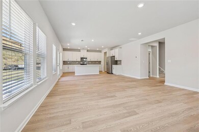 Unfurnished living room with recessed lighting, stairs, and light wood-type flooring