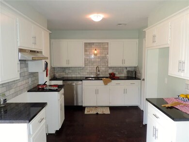 Kitchen with granite countertops, wood floors and 