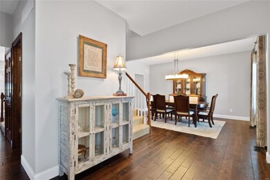 Large open entrance foyer opens to the formal dining room on one side along with access to the open front staircase to the 2nd floor and access to the guest bathroom.