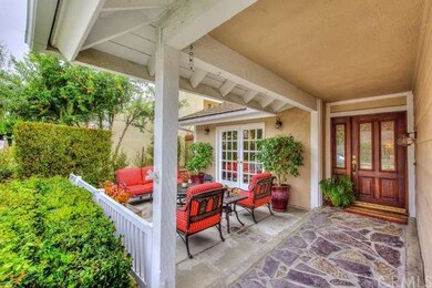 Rich oak doors with leaded glass inserts greet you
