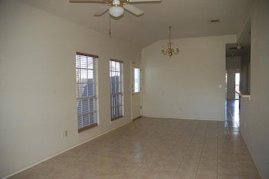 Unfurnished room featuring lofted ceiling, a ceil