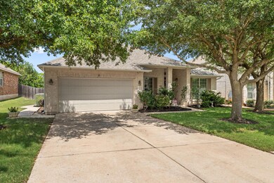 View of front of house featuring brick siding, concrete driveway, a garage, and roof with shingles
