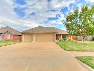 Single story home with a shingled roof, brick siding, driveway, and an attached garage
