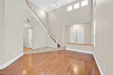 Unfurnished living room with a high ceiling, crown