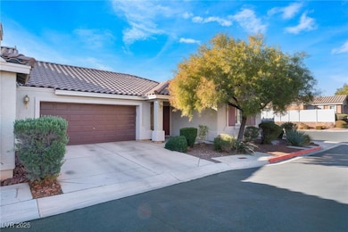 View of front of house with stucco siding, a garag