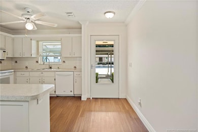 Kitchen has Wood Cabinetry, Updated Appliances, Breakfast Bar with Extra Storage