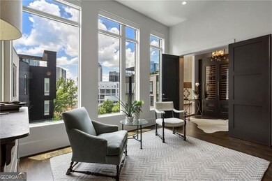 Living area with wood finished floors, a chandelier, and a view of city
