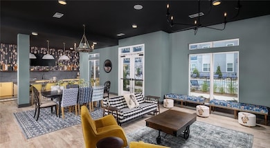 Living room featuring a chandelier, wood finished floors, and french doors