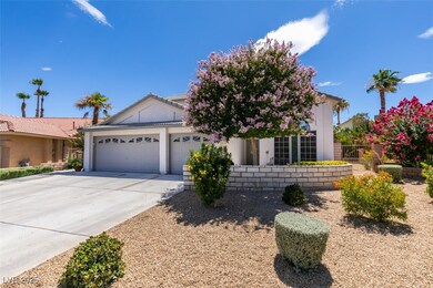 View of front of home with an attached garage, con