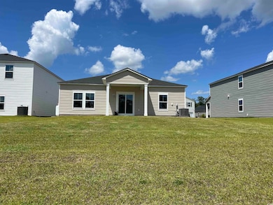 Back of property featuring a yard