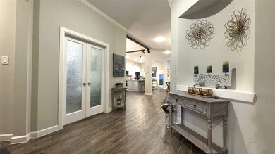 Step inside to a grand foyer with soaring ceilings