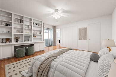 Primary bedroom with built-in bookcase, desk, and