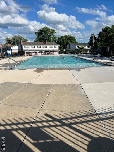 Community pool with a patio area