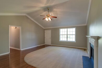 Living room boasts volume ceiling and beautiful crown molding!