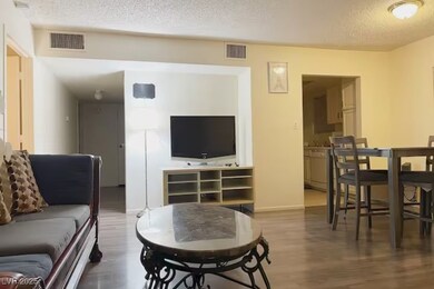 Living area featuring a textured ceiling and wood
