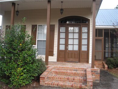 Inviting entrance with brick porch