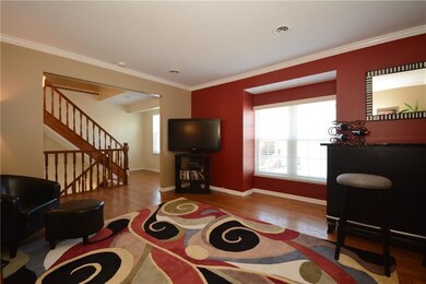Living room welcomes you with hardwood floors and 