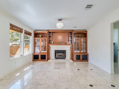 Unfurnished living room featuring ornamental mold