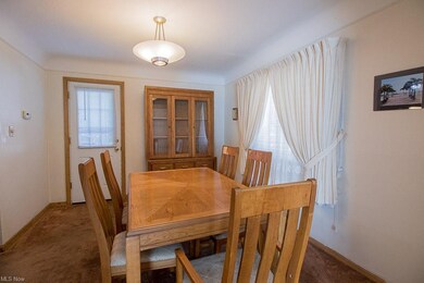 Formal dining area leads to deck in rear yard.