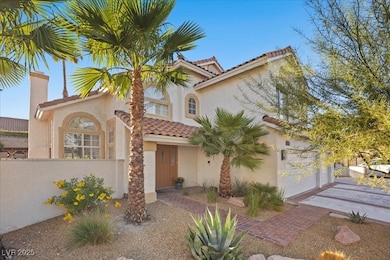Mediterranean / spanish house featuring stucco siding, a chimney, a tile roof, and driveway